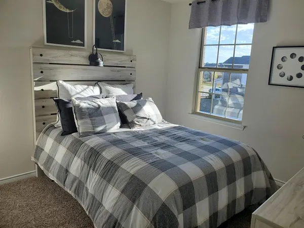 a bedroom with a bed and window