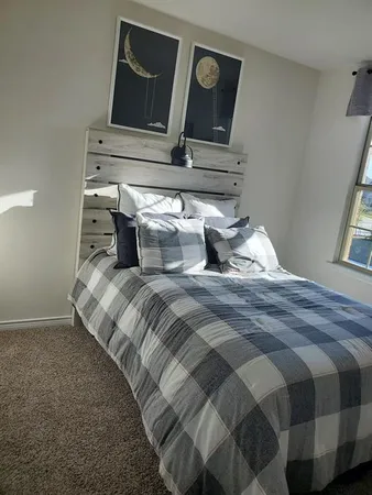 a bedroom with a bed and night stand