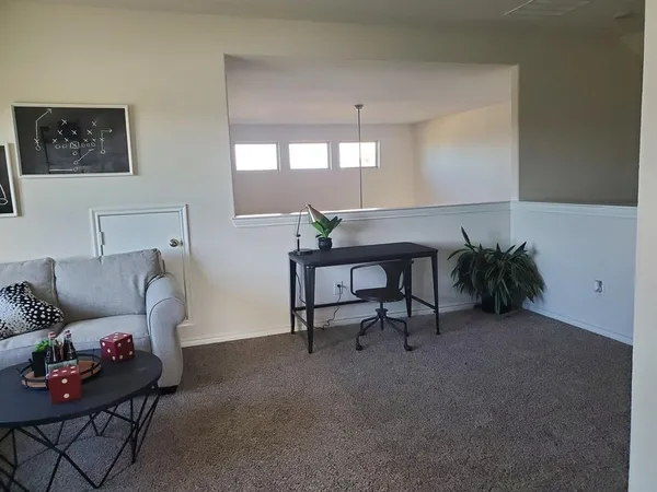 a living room with furniture and a potted plant