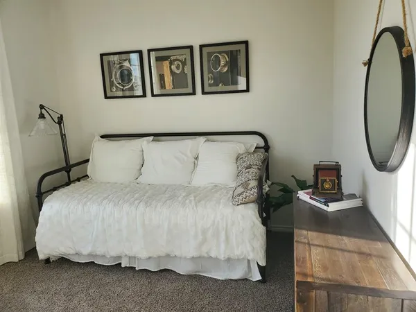 a bedroom with a bed and a mirror