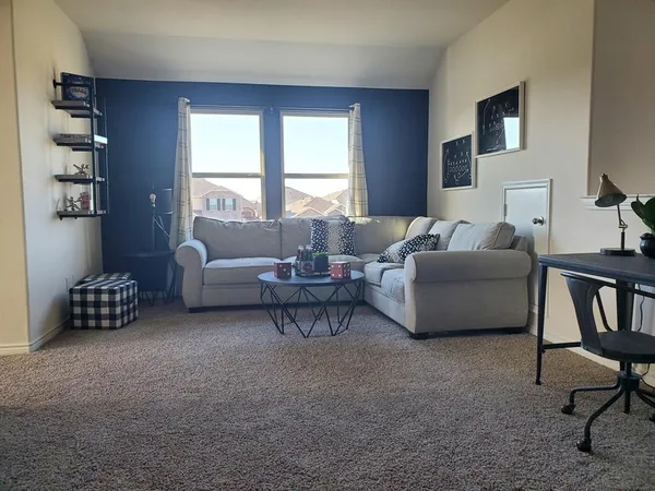 a living room with furniture and a window