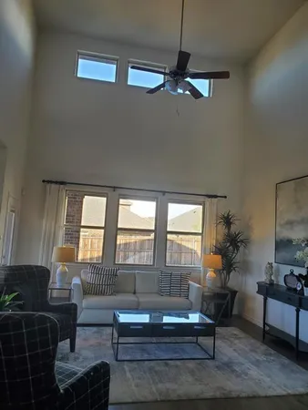 a living room with furniture and a potted plant