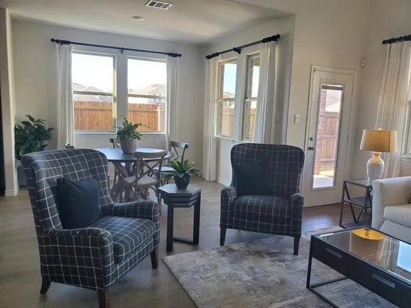 a living room with furniture and a large window