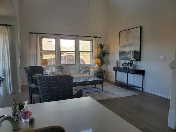 a living room with furniture and a potted plant