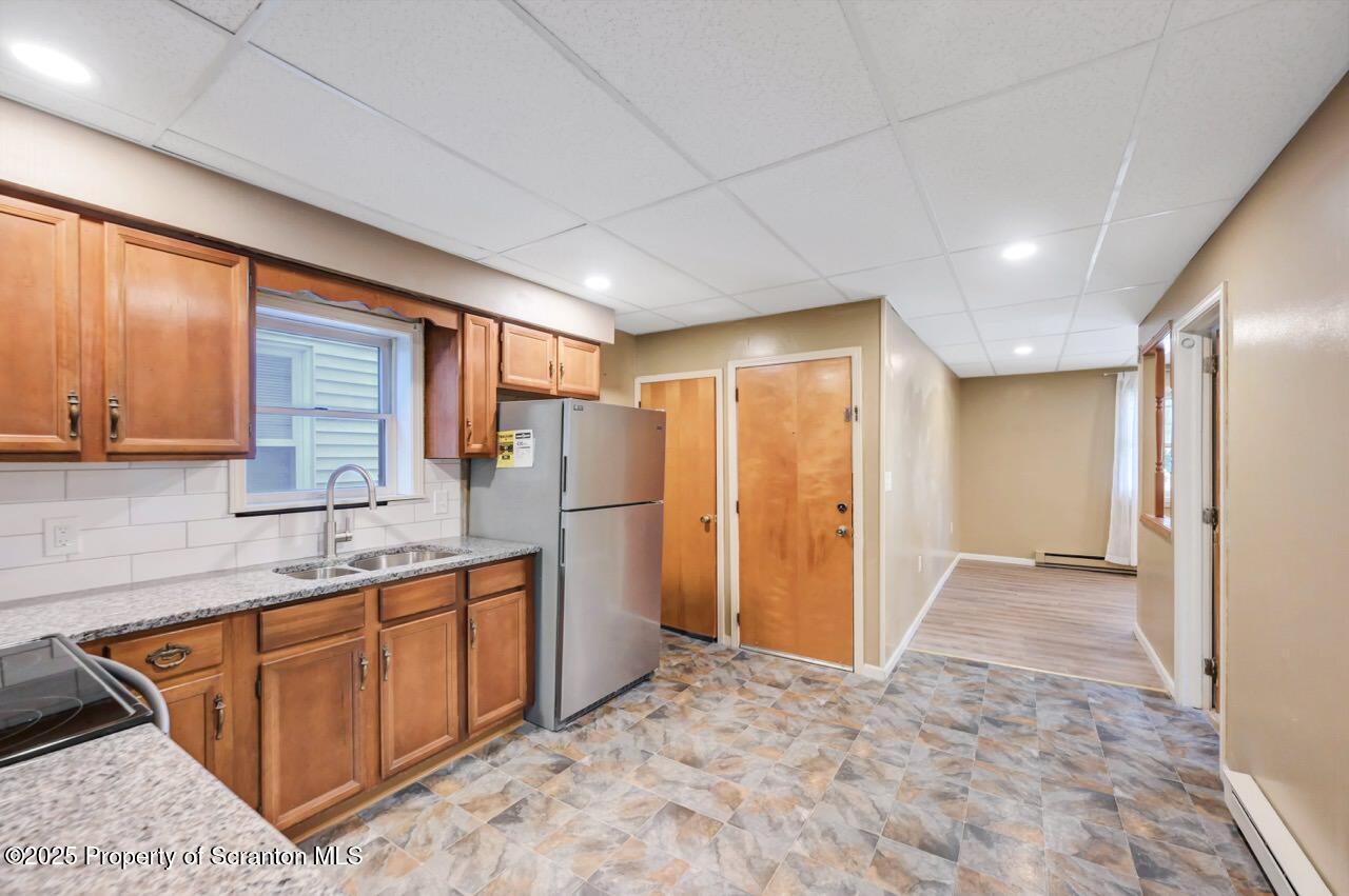 601 Dean Street Scranton, PA 18509 - Photo 15 of 58 a kitchen with stainless steel appliances granite countertop a refrigerator and a sink