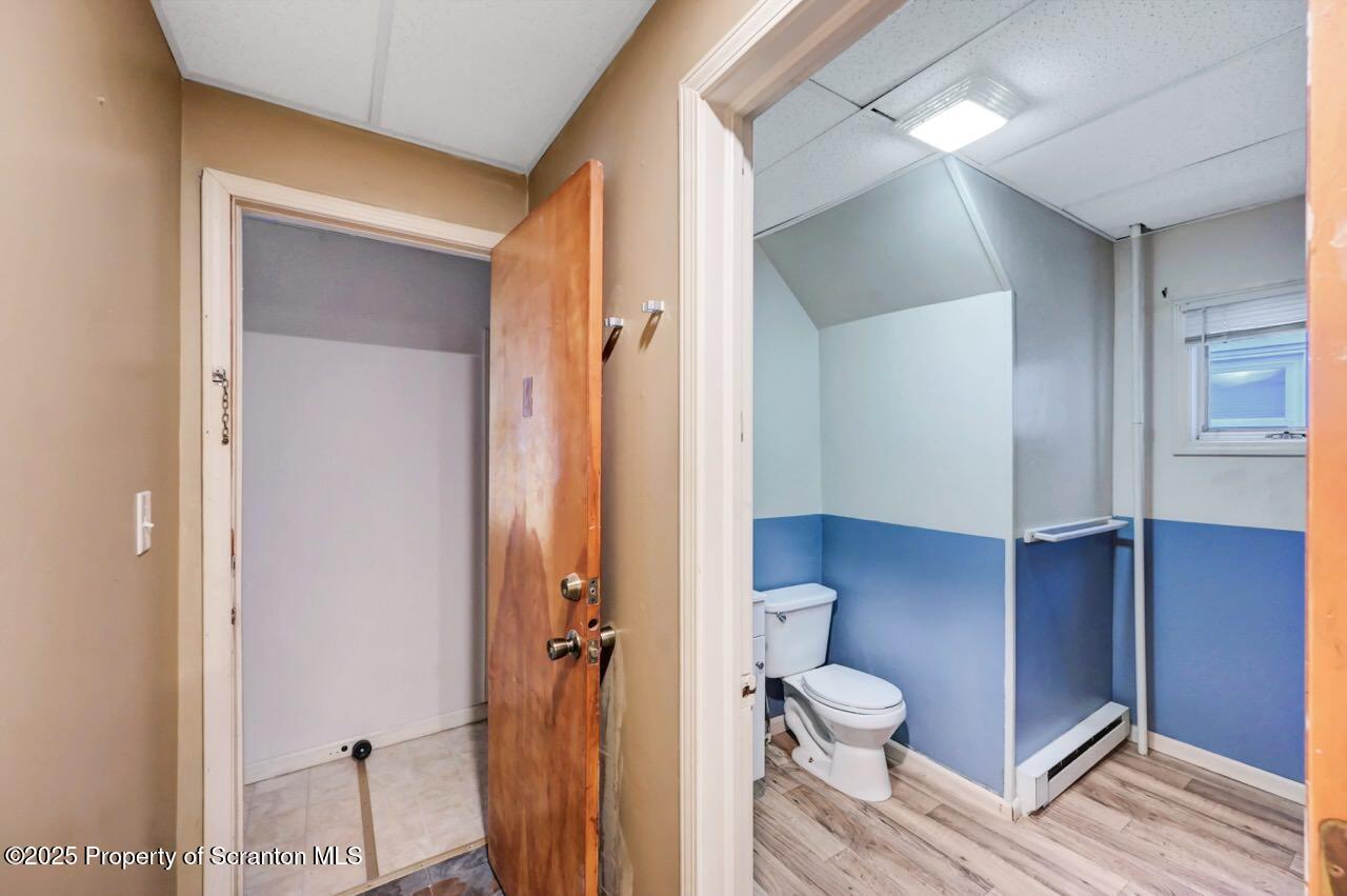 601 Dean Street Scranton, PA 18509 - Photo 19 of 58 a bathroom with a toilet shower and a mirror