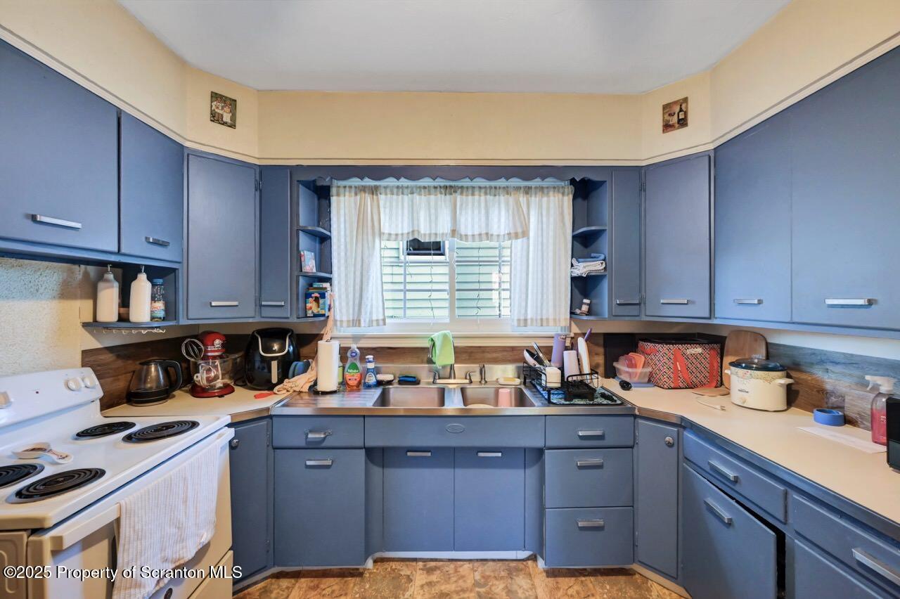 601 Dean Street Scranton, PA 18509 - Photo 37 of 58 a kitchen with lots of counter top space and cabinets