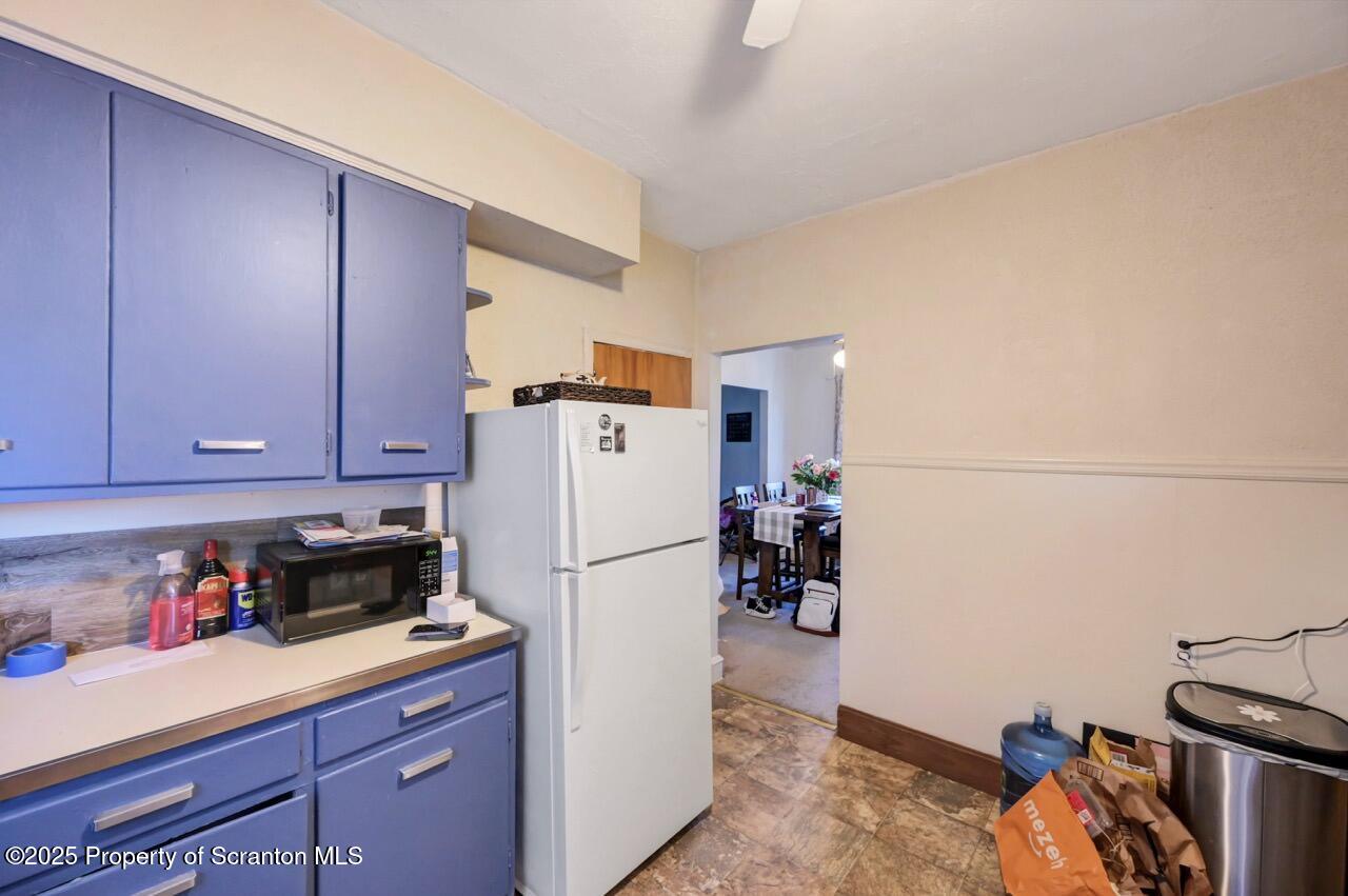 601 Dean Street Scranton, PA 18509 - Photo 38 of 58 a kitchen with a refrigerator and a stove top oven