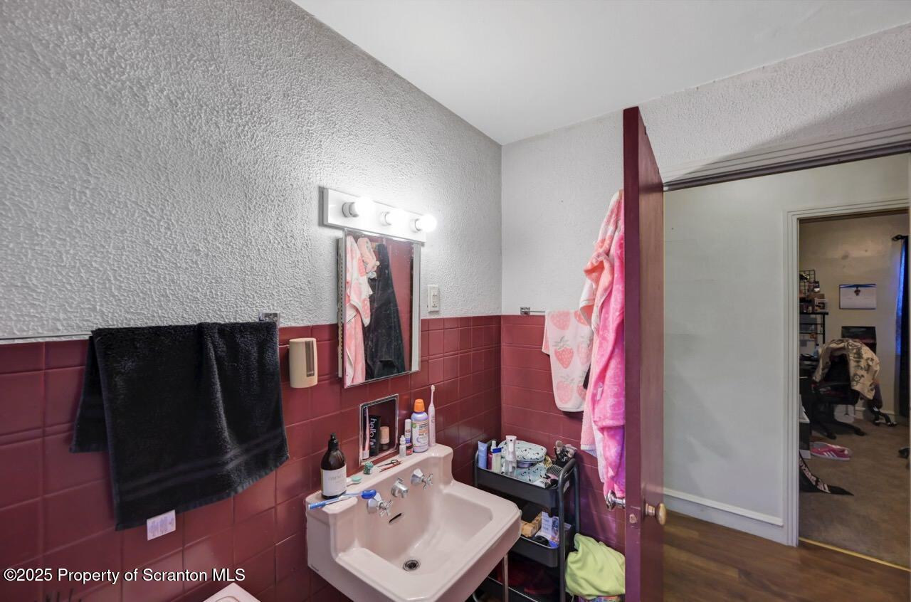 601 Dean Street Scranton, PA 18509 - Photo 40 of 58 a bathroom with a sink and a mirror
