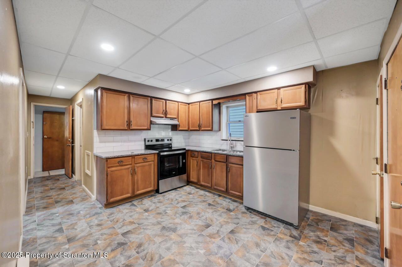 601 Dean Street Scranton, PA 18509 - Photo 4 of 58 a large kitchen with stainless steel appliances granite countertop a refrigerator and a sink