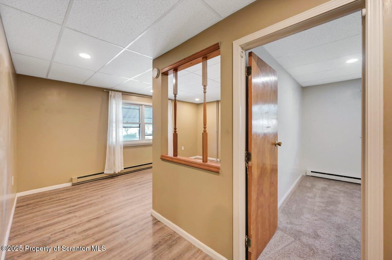 601 Dean Street Scranton, PA 18509 - Photo 5 of 58 an empty room with wooden floor and windows