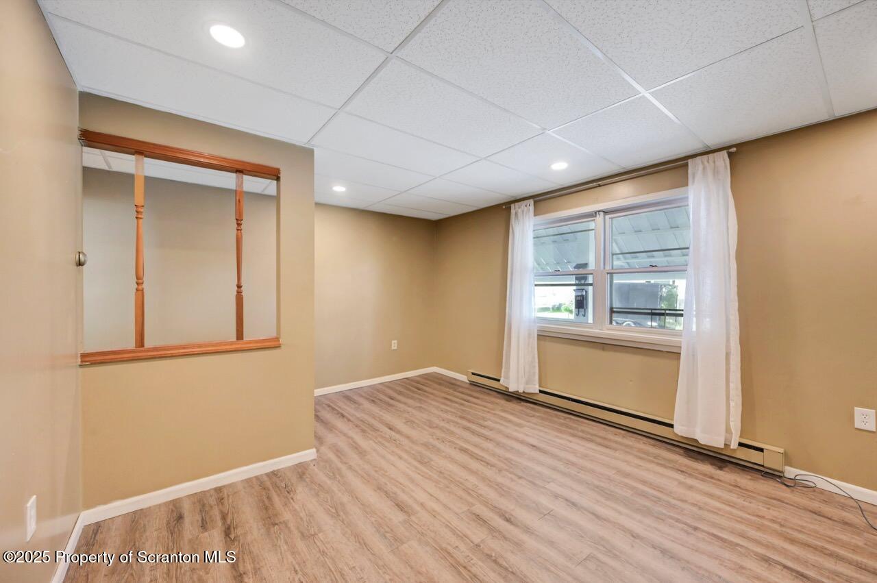 601 Dean Street Scranton, PA 18509 - Photo 9 of 58 a view of an empty room with wooden floor and a window