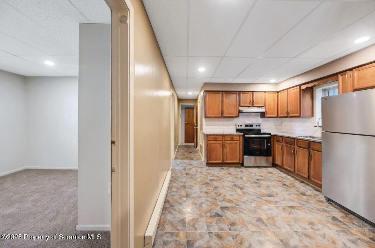 601 Dean Street Scranton, PA 18509 - Photo 10 of 58 a kitchen with granite countertop a refrigerator and a sink