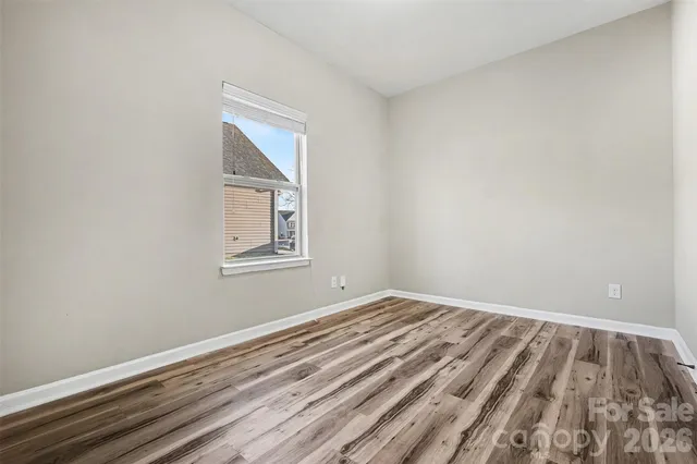 a view of a room with wooden floor and windows