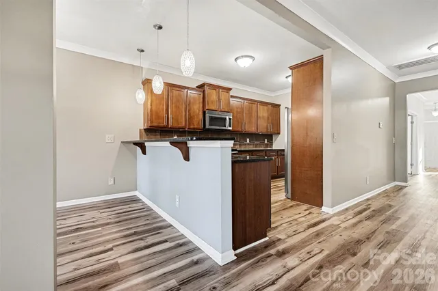 a view of a kitchen with wooden floor