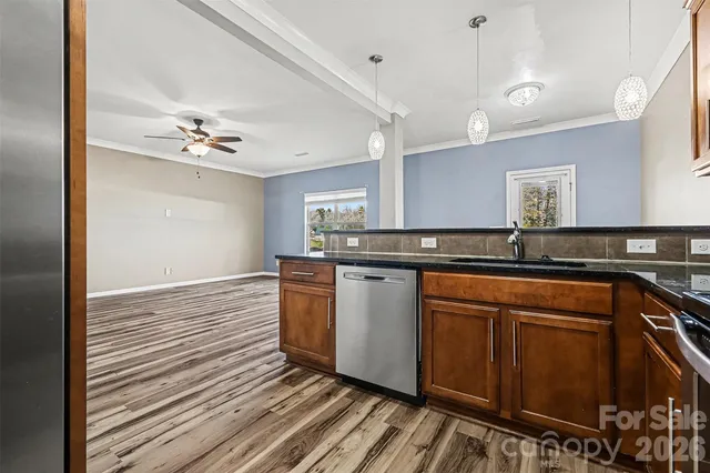 a kitchen with stainless steel appliances granite countertop a sink and cabinets