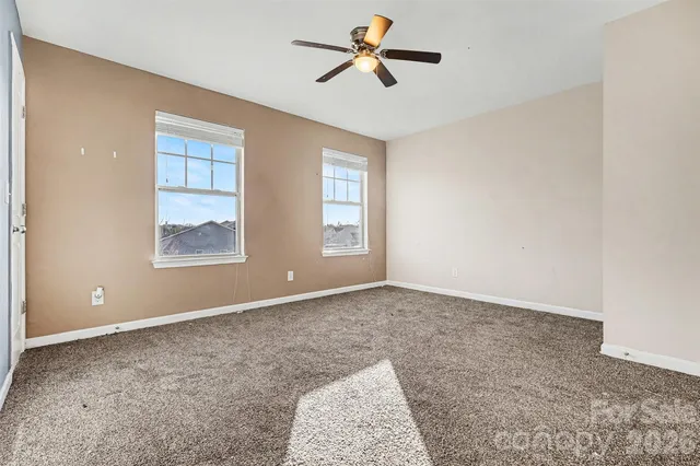 a view of a room with window and ceiling fan