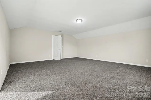 an empty room with ceiling fan and window