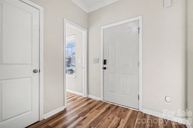 a view of a room with wooden floor