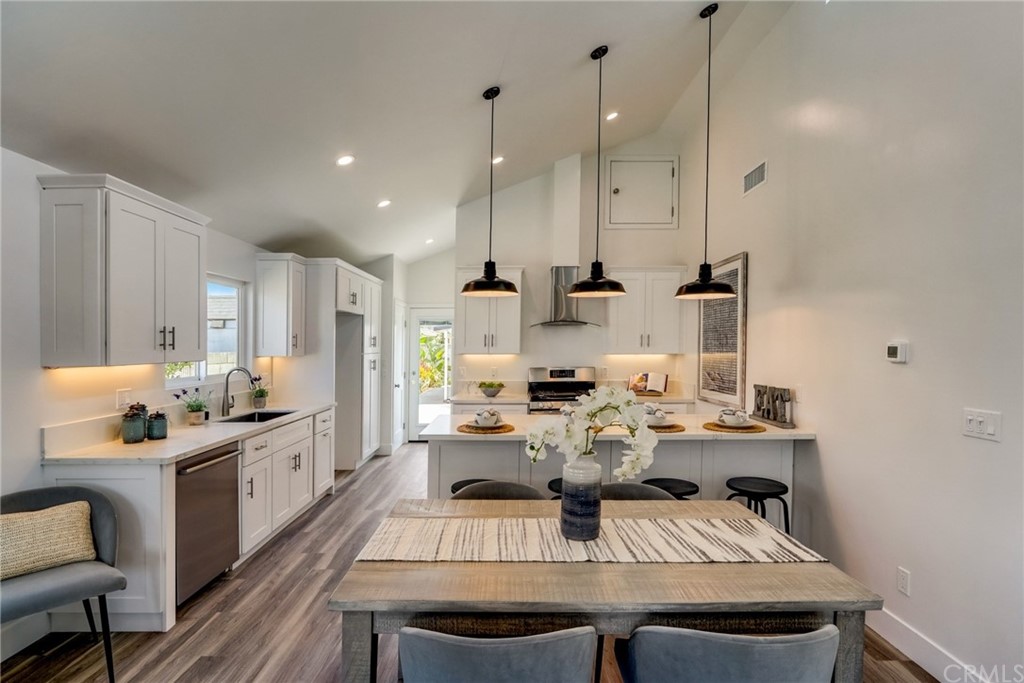 4566 166th Street Lawndale, CA 90260 - Photo 11 of 64 a large kitchen with a table and chairs