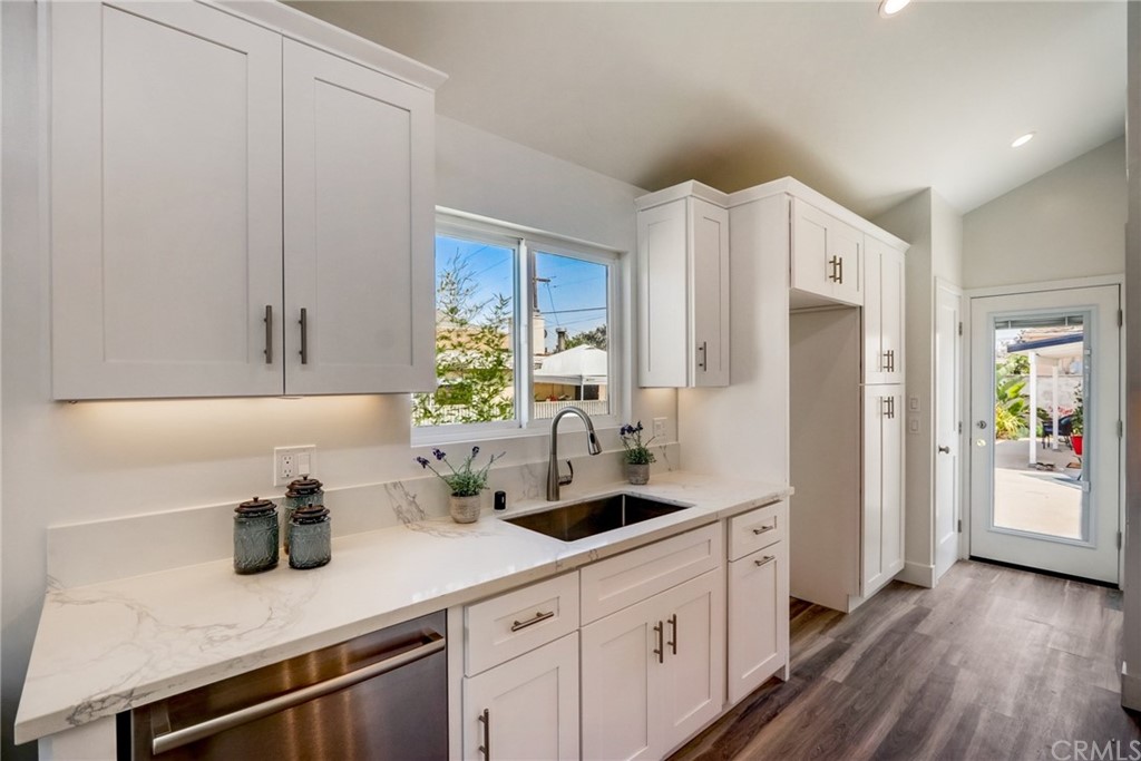 4566 166th Street Lawndale, CA 90260 - Photo 14 of 64 a kitchen with stainless steel appliances white cabinets and a wooden floor