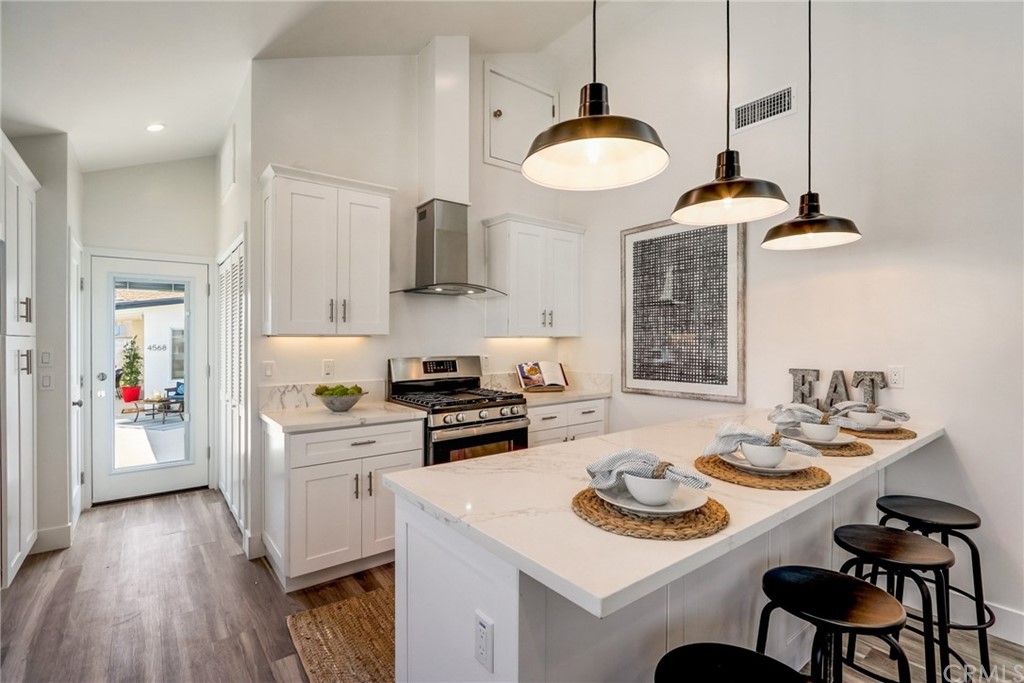 4566 166th Street Lawndale, CA 90260 - Photo 15 of 64 a kitchen with stainless steel appliances a table chairs and a stove top oven