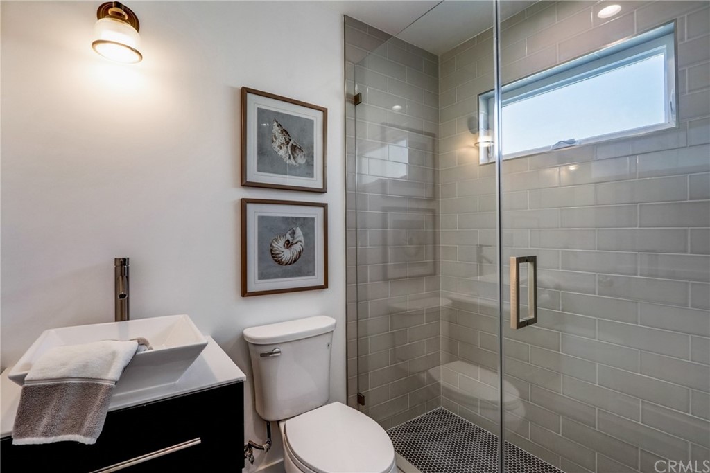 4566 166th Street Lawndale, CA 90260 - Photo 29 of 64 a white toilet sitting next to a bathroom sink