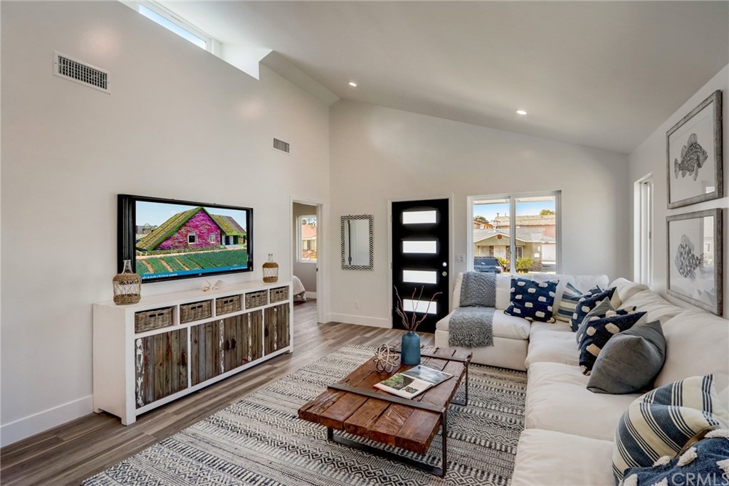 4566 166th Street Lawndale, CA 90260 - Photo 8 of 64 a living room with furniture a rug and a flat screen tv