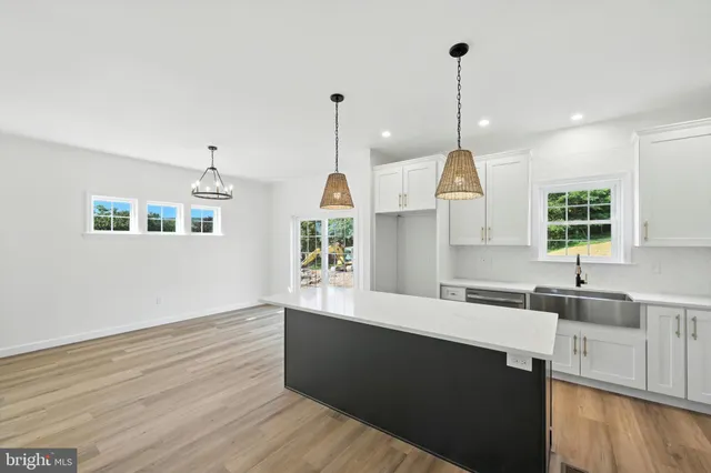 a kitchen with a sink cabinets and window