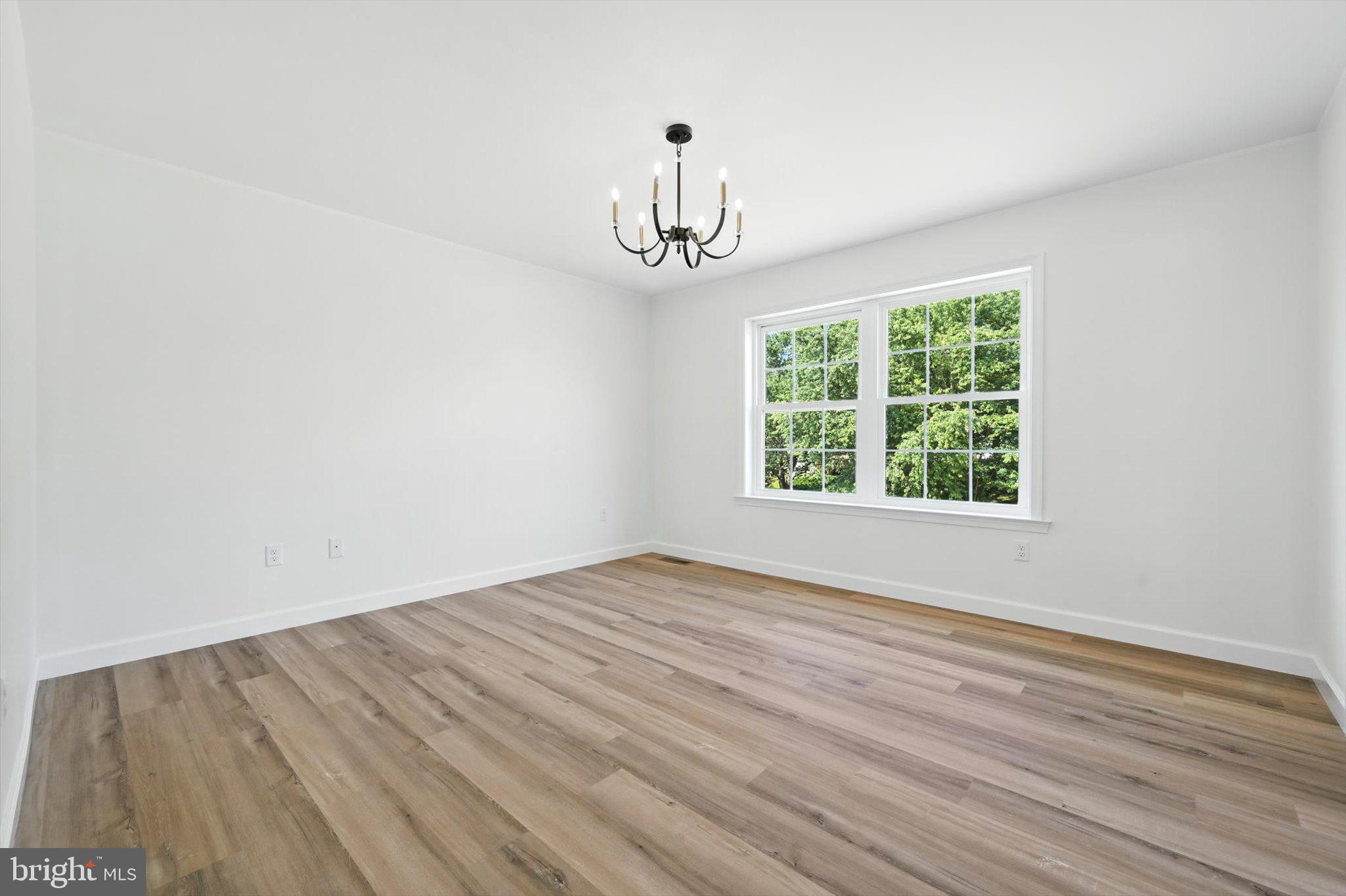 57 Ardmore Avenue Tamaqua, PA 18252 - Photo 17 of 34 an empty room with wooden floor chandelier and windows