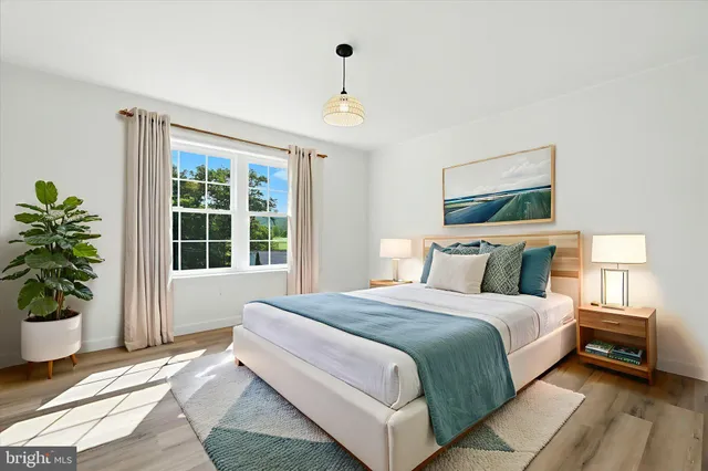 a spacious bedroom with a large bed and a potted plant