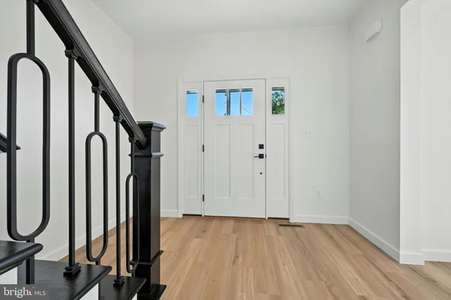 a view of a room with staircase and mirror