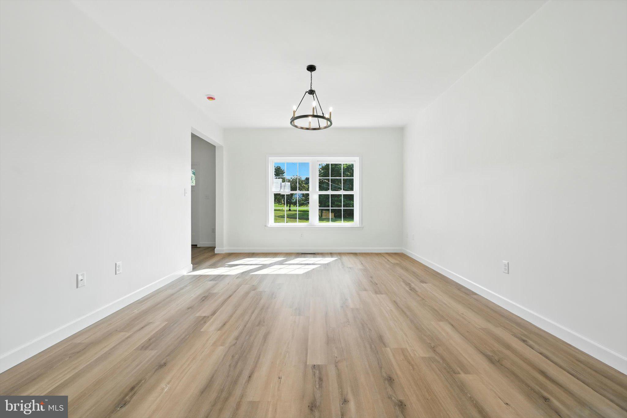57 Ardmore Avenue Tamaqua, PA 18252 - Photo 7 of 34 an empty room with wooden floor windows and cabinet
