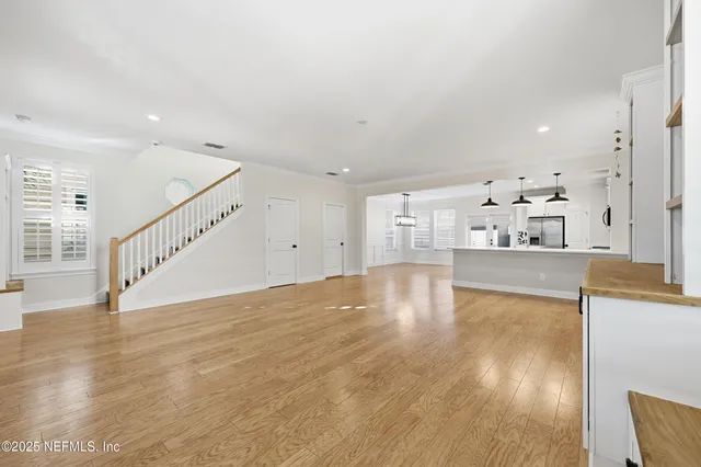 a view of kitchen and hall with wooden floor