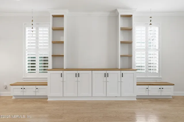 a view of kitchen with windows and cabinet