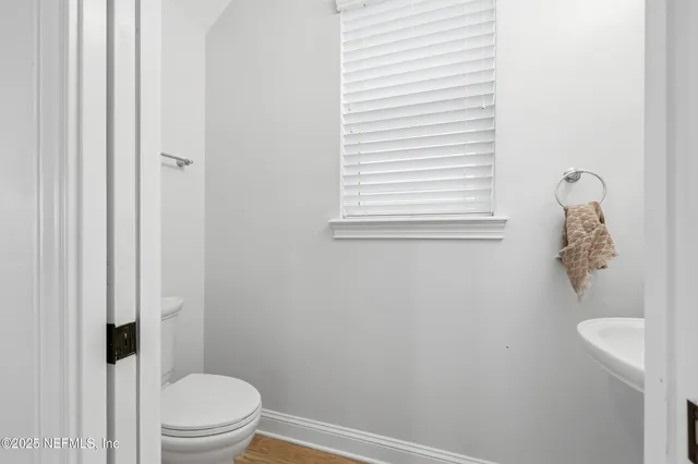 a white toilet sitting next to a bathroom sink