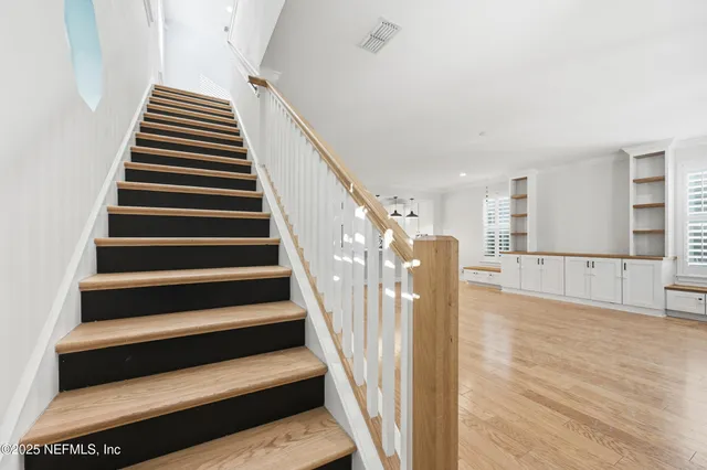 a view of entryway and hall with wooden floor
