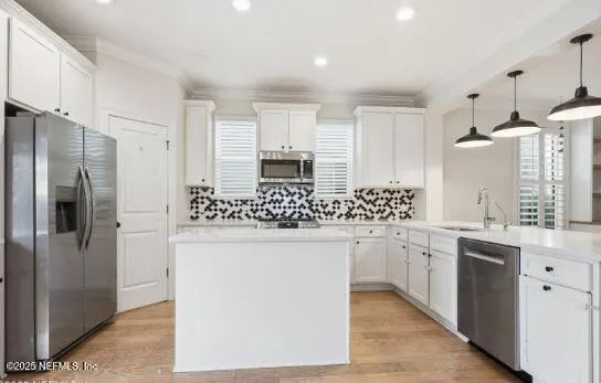 a kitchen with stainless steel appliances a sink stove and refrigerator