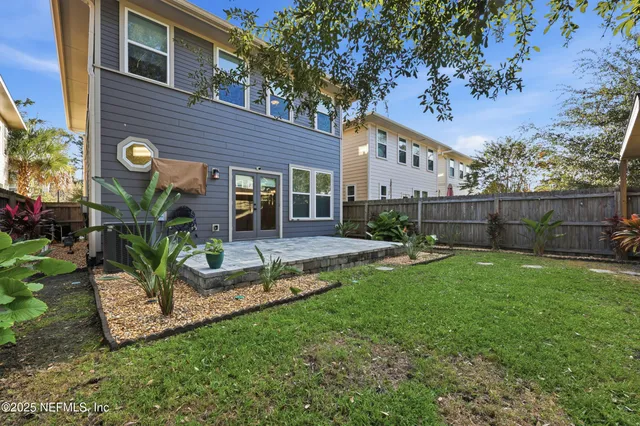 a view of house with a backyard