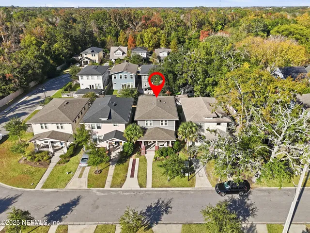 an aerial view of residential houses with outdoor space