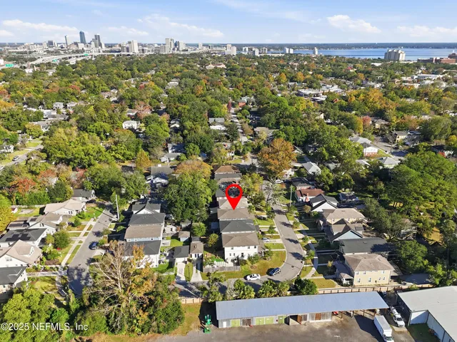 an aerial view of residential houses with city view