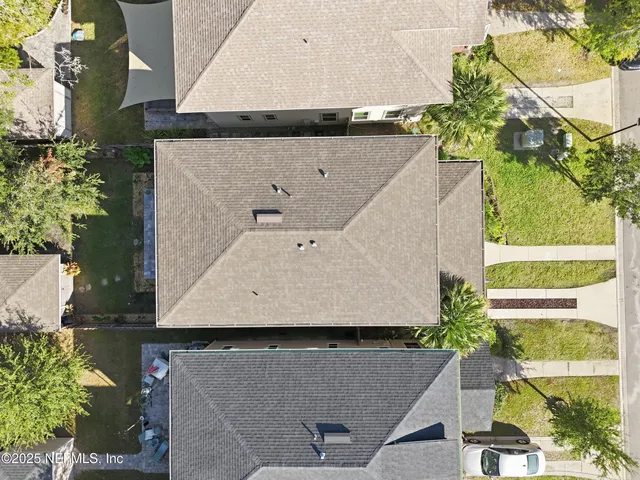 an aerial view of a house with a yard