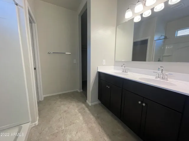 a bathroom with a sink vanity and mirror