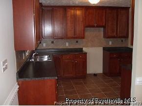 134 Wallflower Road Raeford, NC 28376 - Photo 4 of 9 a kitchen with granite countertop stainless steel appliances a stove a microwave and a sink