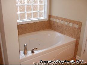 134 Wallflower Road Raeford, NC 28376 - Photo 7 of 9 a bath tub sitting next to a window