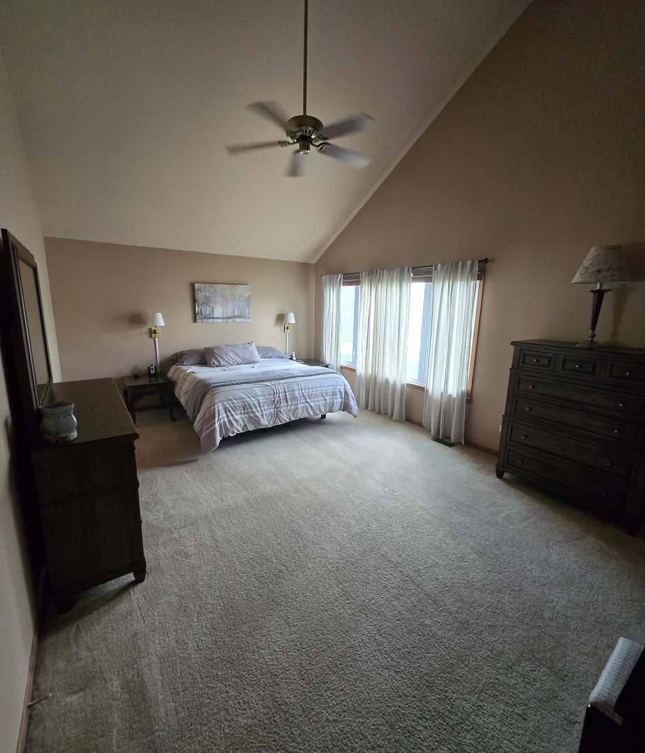 8141 Old Mill Road Frankfort, IL 60423 - Photo 24 of 39 a spacious bedroom with a bed and a ceiling fan