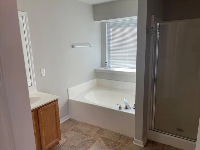 a bathroom with a bathtub and a shower
