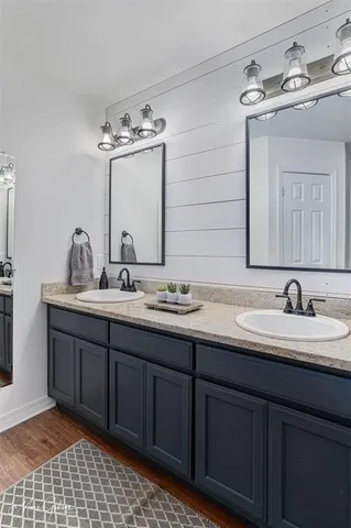a bathroom with a double vanity sink mirror and