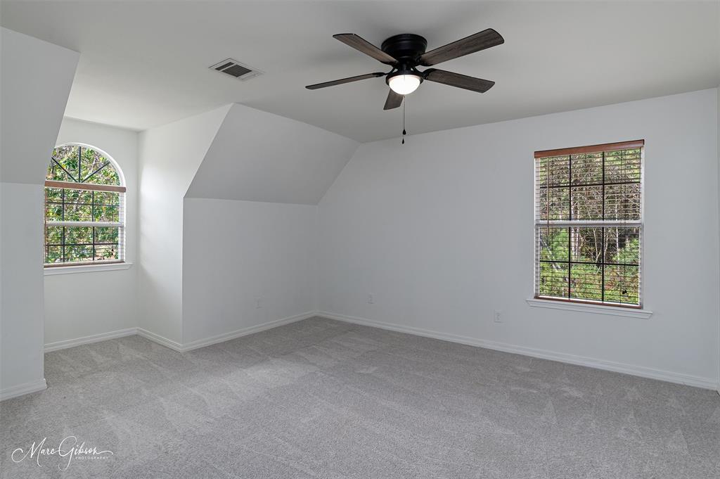 1140 Linton Road Benton, LA 71006 - Photo 22 of 39 an empty room with windows and fan