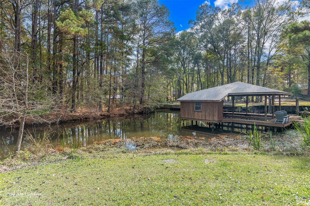 1140 Linton Road Benton, LA 71006 - Photo 35 of 39 a backyard of a house with yard lake and outdoor seating